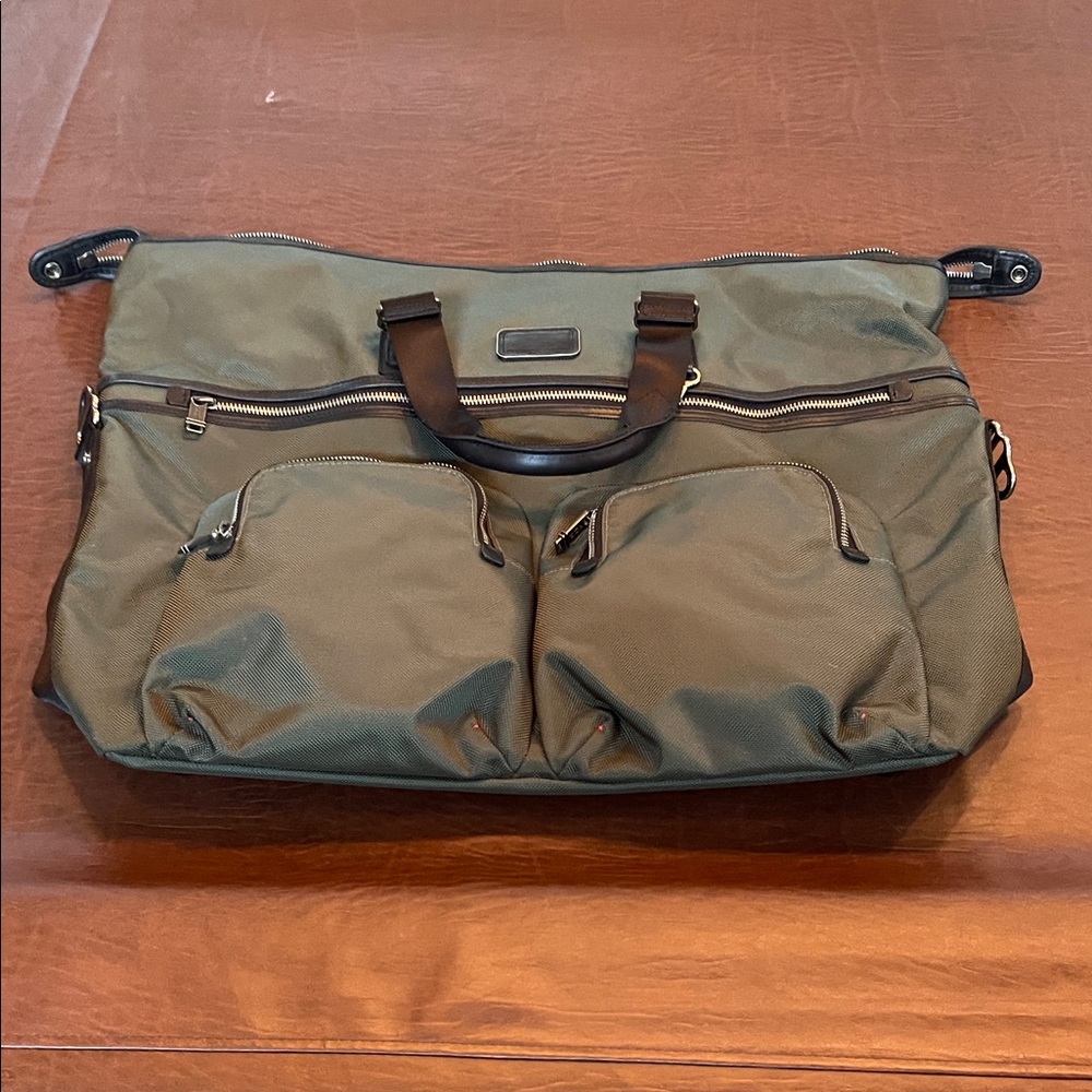 Tumi Olive Kessler Duffel Bag. Never used. Tags on.  Missing long strap.